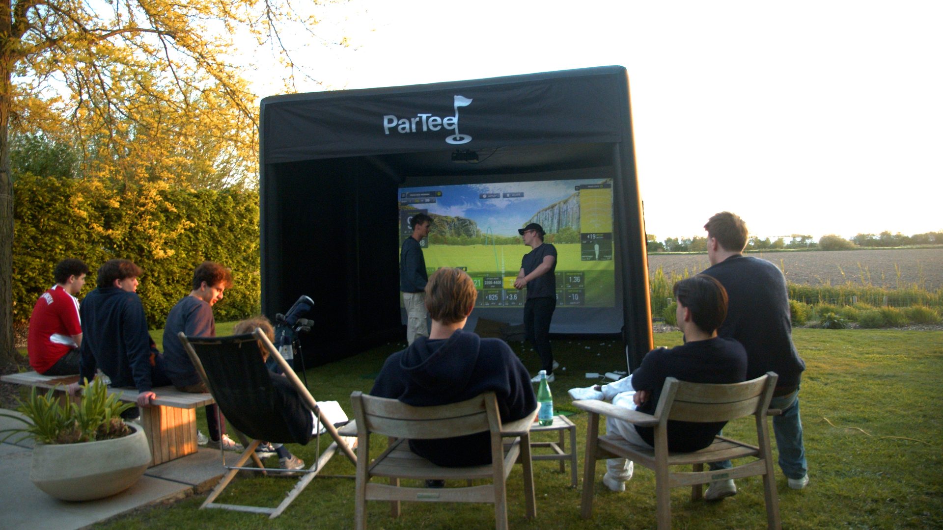 ParTee simulator set up in a garden with a group of friends