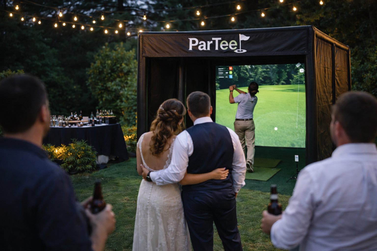 Wedding couple watching a guest play the ParTee golf simulator